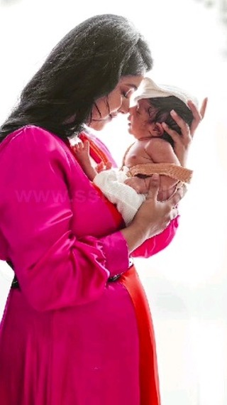 Kavita Gowda poses for a photoshoot with her son