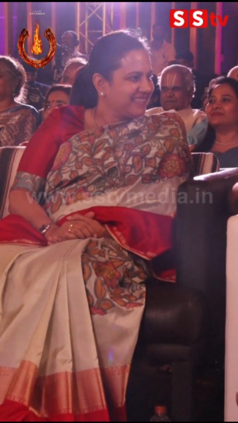 Ashwini Puneeth Rajkumar sitting happily talking to Pooja Gandhi