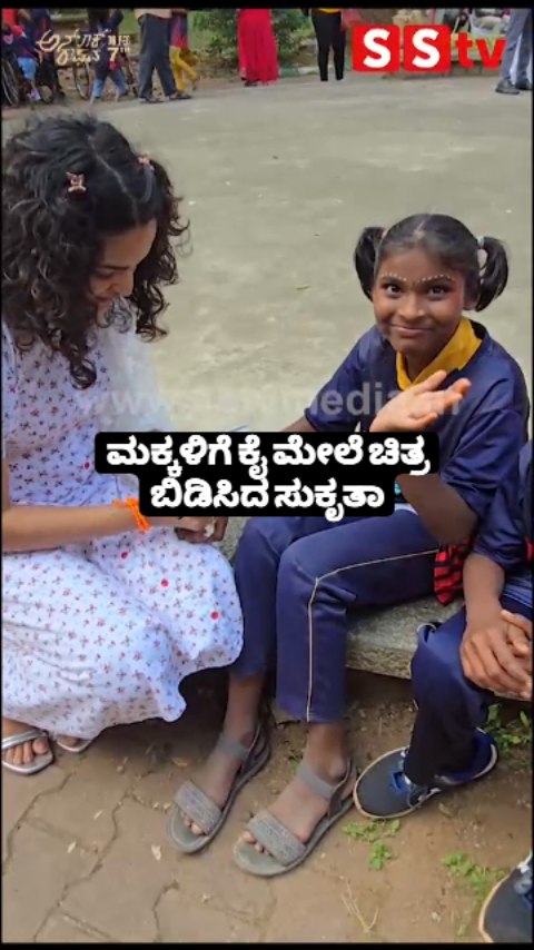 Sukrutha draws pictures on children's hands