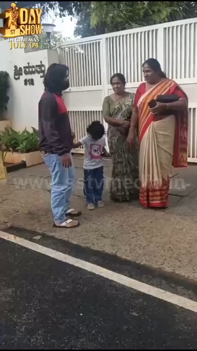 Madenur Manu waiting in front of Shivanna's house with his wife and child